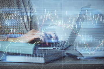 Double exposure of woman hands typing on computer and forex chart hologram drawing. Stock market analysis concept.