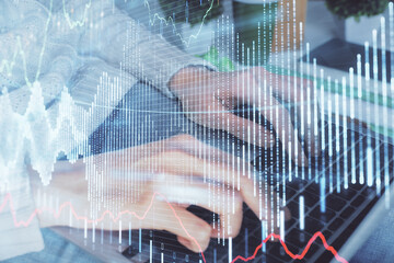 Double exposure of woman hands typing on computer and forex chart hologram drawing. Stock market invest concept.