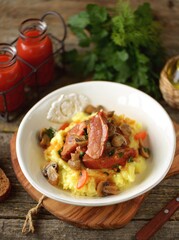 Smoked pork ribs stewed with mushrooms, onions and carrots in tomato sauce served with mashed potatoes.