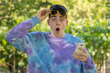 surprised young teenager with mobile phone