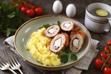 Meat roll stuffed with jamon and feta cheese with mashed potatoes.