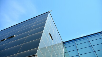 Commercial building close up. Abstract texture of blue glass modern building. Business background.
