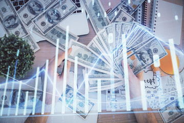 Multi exposure of financial graph drawing hologram and USA dollars bills and man hands. Analysis concept.