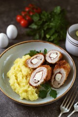 Meat roll stuffed with jamon and feta cheese with mashed potatoes.