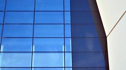 Abstract image of looking up at modern glass and concrete building. Architectural exterior detail of office building. Industrial art and detail.