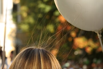 Girl's hair electrified by a balloon