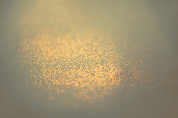 Vintage abstract yellow background with small bokeh defocused lights.