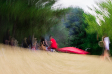 Bright photo with blurred view of group of people.