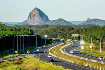The Bruce Highway, looking south,  with Tibrogargan of the the Glasshouse Mountains in the background; Sunshine Coast Hinterland, Queensland, Australia.