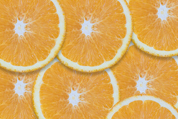 Background with oranges cut into pieces. Close-up texture.