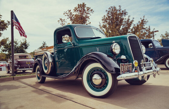 Front side view of a dark green 1937 Ford pickup truck classic car on October 17, 2015, in Westlake, Texas.