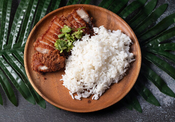 Pork fried rice on a dark tone wooden plate