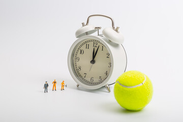 Green tennis ball and worker on white background