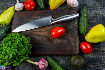 Pepper, garlic, tomato, cucumber, basil on a cutting board