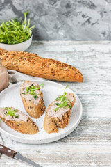 Turkey liver pate on whole grain baguette with microgreens
