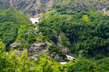 View of the beautiful countryside of North Ossetia. Sunny day. Beautiful summer landscape in the mountains. Grassy fields and hills. Rural landscapes