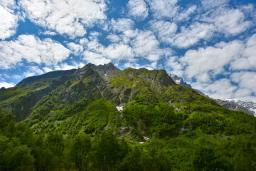 View of the beautiful countryside of North Ossetia. Sunny day. Beautiful summer landscape in the mountains. Grassy fields and hills. Rural landscapes