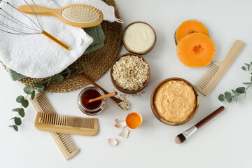 Fototapeta na wymiar Homemade body care natural cosmetic products top view. Body, face mask with pumpkin, oatmeal, honey, egg and yogurt to moisturize. Self care concept