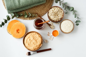 Homemade body care natural cosmetic products top view. Body, face mask with pumpkin, oatmeal,...
