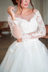 Fototapeta na wymiar The torso of a bride in a white wedding dress