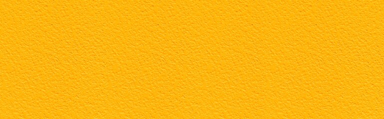 Panorama of Patterned cement wall Vintage yellow painted texture and background