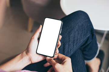 cell phone mockup image blank white screen.woman hand holding texting using mobile on desk at coffee shop.background empty space for advertise.work people contact marketing business,technology