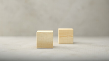 empty wooden cubes for own messages and icons on paper floor in front of a concrete wall