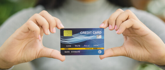 Young female holding credit card, Online shopping or paying concept.
