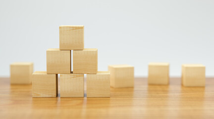 empty wooden cubes for own messages and icons on wooden floor and white background