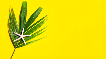Fototapeta na wymiar Starfish on tropical palm leaves on yellow background. Enjoy summer holiday concept. Top view