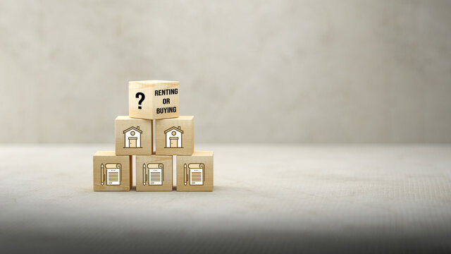 cubes with house and conctract symbols and message RENTING OR BUYING on paper floor and concrete background
