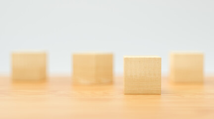 empty wooden cubes for own messages and icons on wooden floor and white background