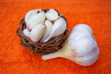 Cloves of raw Garlic in wooden small vintage nest as bowl. Spices for cooking