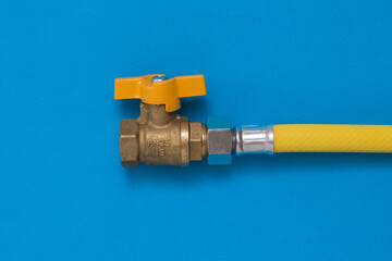 Gas tap with yellow hose on a blue background.
