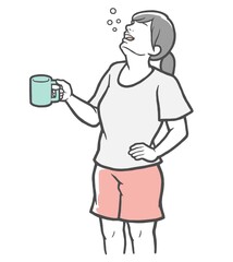 腰に手をあててうがいをする若い女性