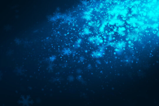 Blue many snowflakes differrent size falling from side scene with  blue spot light  on dark blue background