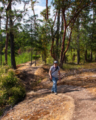 Active Senior hiking along woodland ridge in the fall