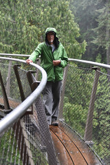 Active senior walking on suspended boardwalk in rain