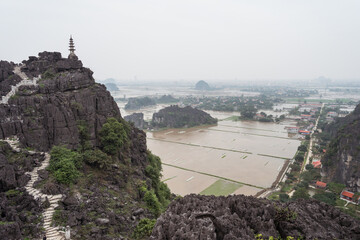 beautiful landscape with mountain pagoda at Bich Dong with flooded rice fields and cloudy sky