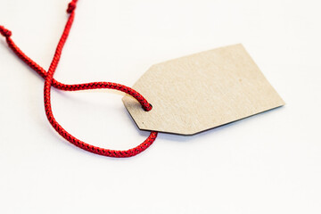 Blank tag tied with string. Price tag, gift tag, sale tag, address label isolated.