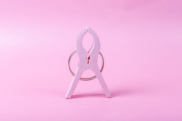 Large plastic clips on pink background