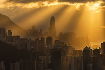 Silhouette of skyline of downtown of Hong Kong city with sun ray under sunset