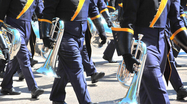 Marching band in a parade outside.