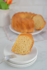 Fresh bundt cake on a wooden cutting board 