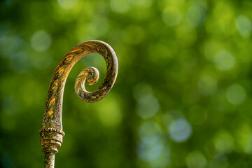 Close-up of the upper part of a bishop's crozier - obrazy, fototapety, plakaty