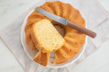 Fresh bundt cake on a wooden cutting board 