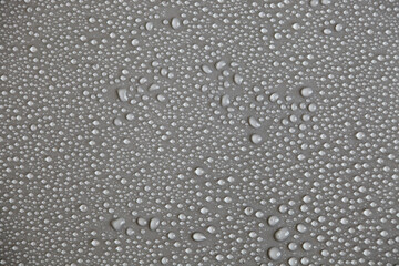 Details of water droplets, moisture condensation, hot water vapor condensation on a neutral background close-up