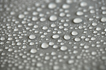 Details of water droplets, moisture condensation, hot water vapor condensation on a neutral background close-up