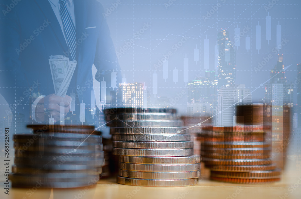 Wall mural double exposure of graph and rows of coins on city night background.