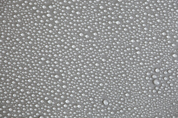 Details of water droplets, moisture condensation, hot water vapor condensation on a neutral background close-up